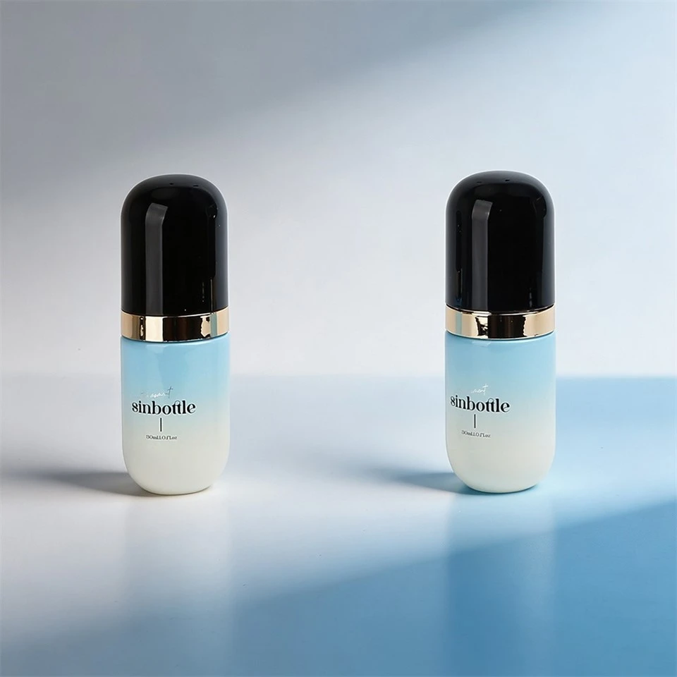 30ml Luxury Capsule Shaped Gradient Blue Glass Foundation Lotion Bottle With Black Cap And Gold Pump suppliers