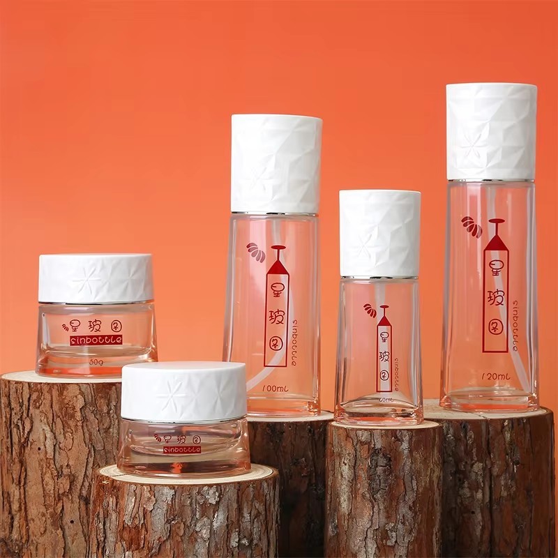 Luxury 50ml 100ml Round Glass Bottles Set For Face Cream Lotion Empty Spray Bottle With Airless Pump Custom Cosmetic Packaging factory